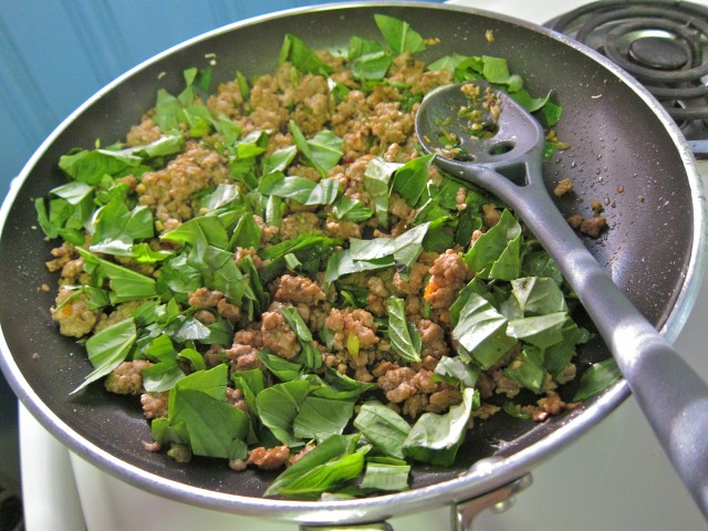 Adding thai basil to pork