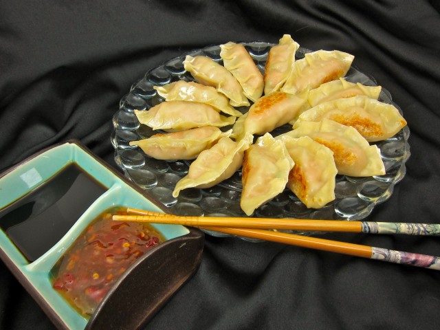Cooked potstickers with dipping sauces