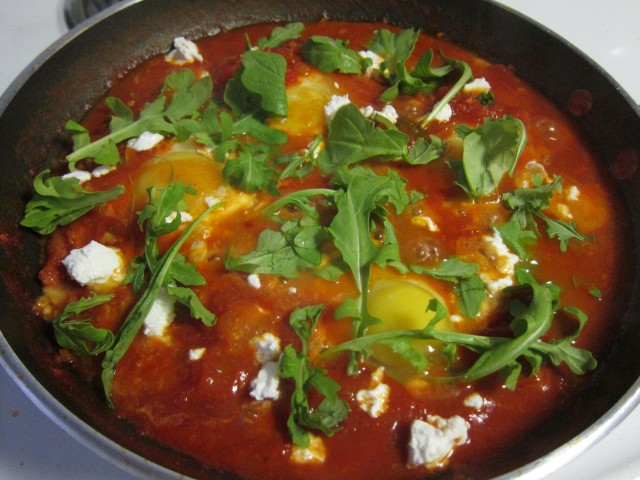 Eggs poaching for shakshuka