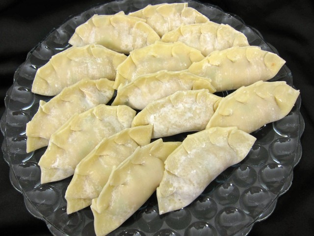 Plate of uncooked potstickers